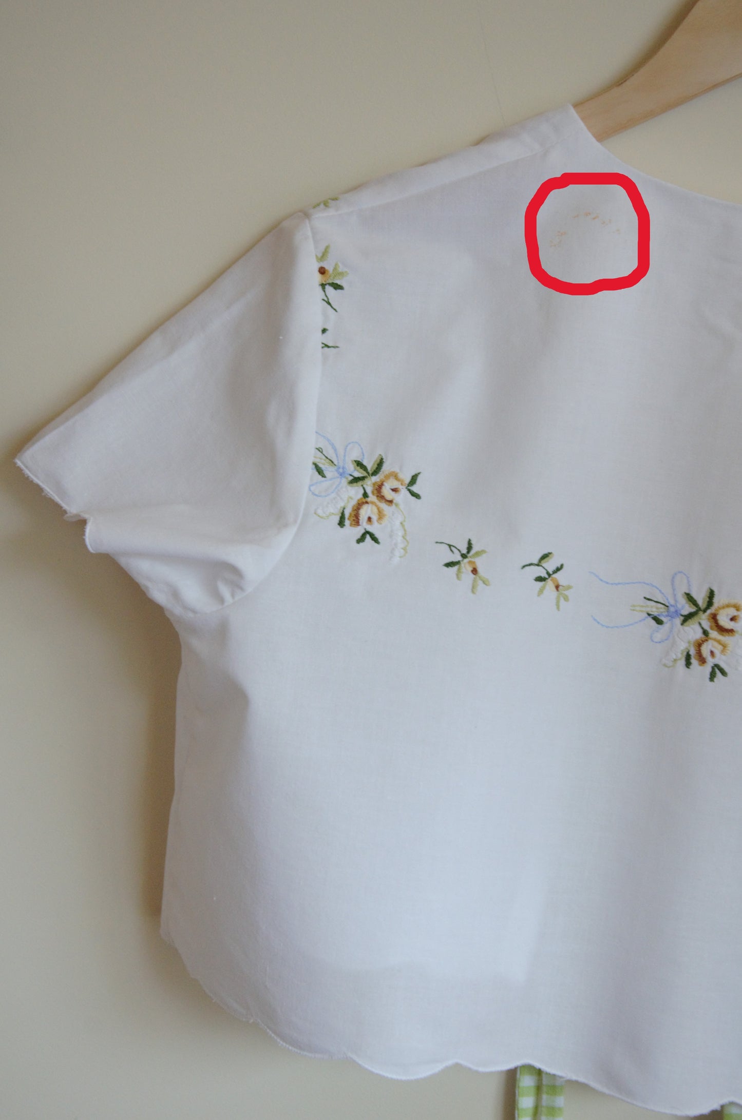 Due to the garment being made out of thrifted fabric, there's a blemish on the back.